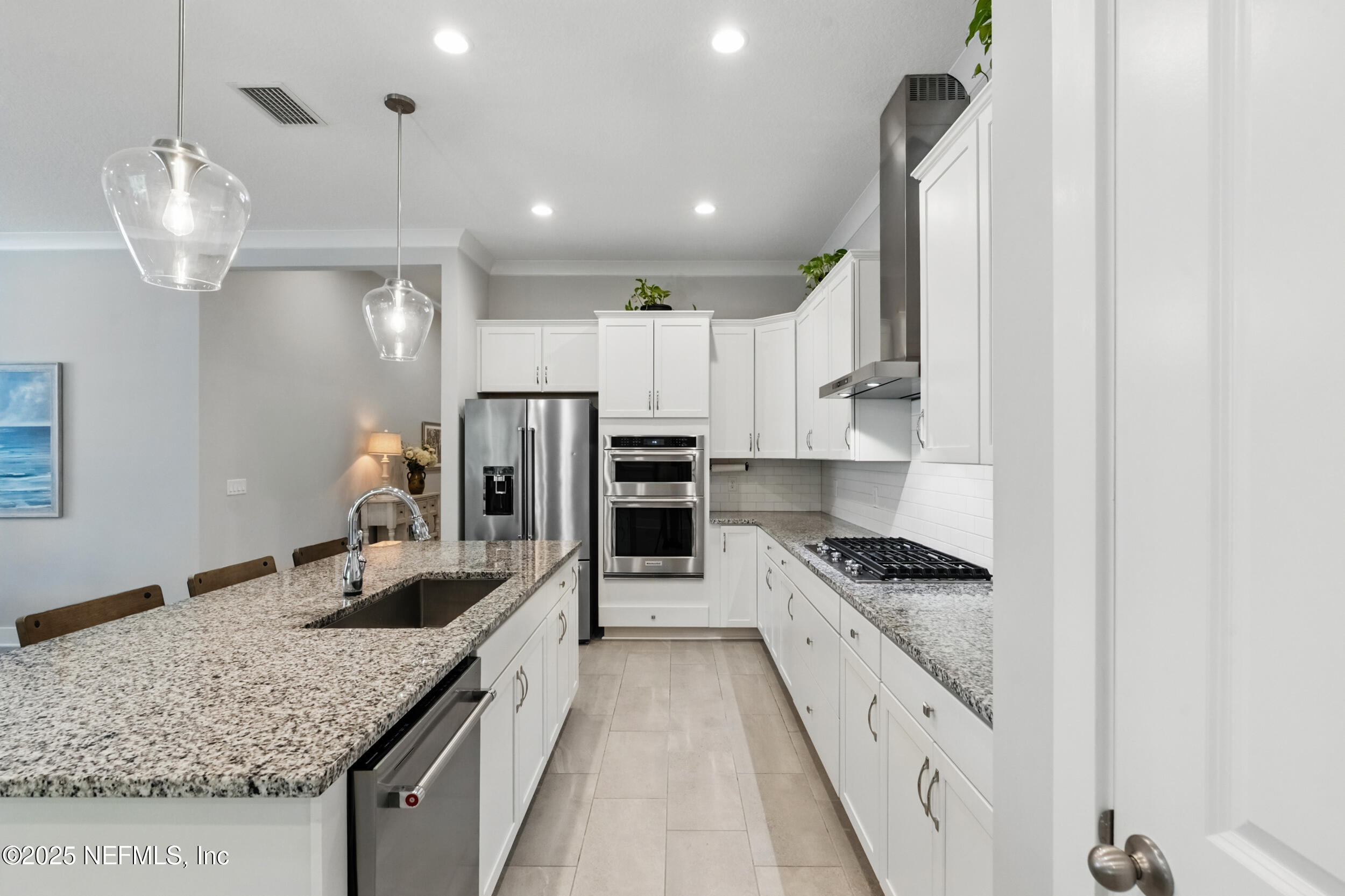 9918 Filament Boulevard Jacksonville, FL 32256 - Photo 10 of 106 a kitchen with stainless steel appliances granite countertop a sink refrigerator and cabinets