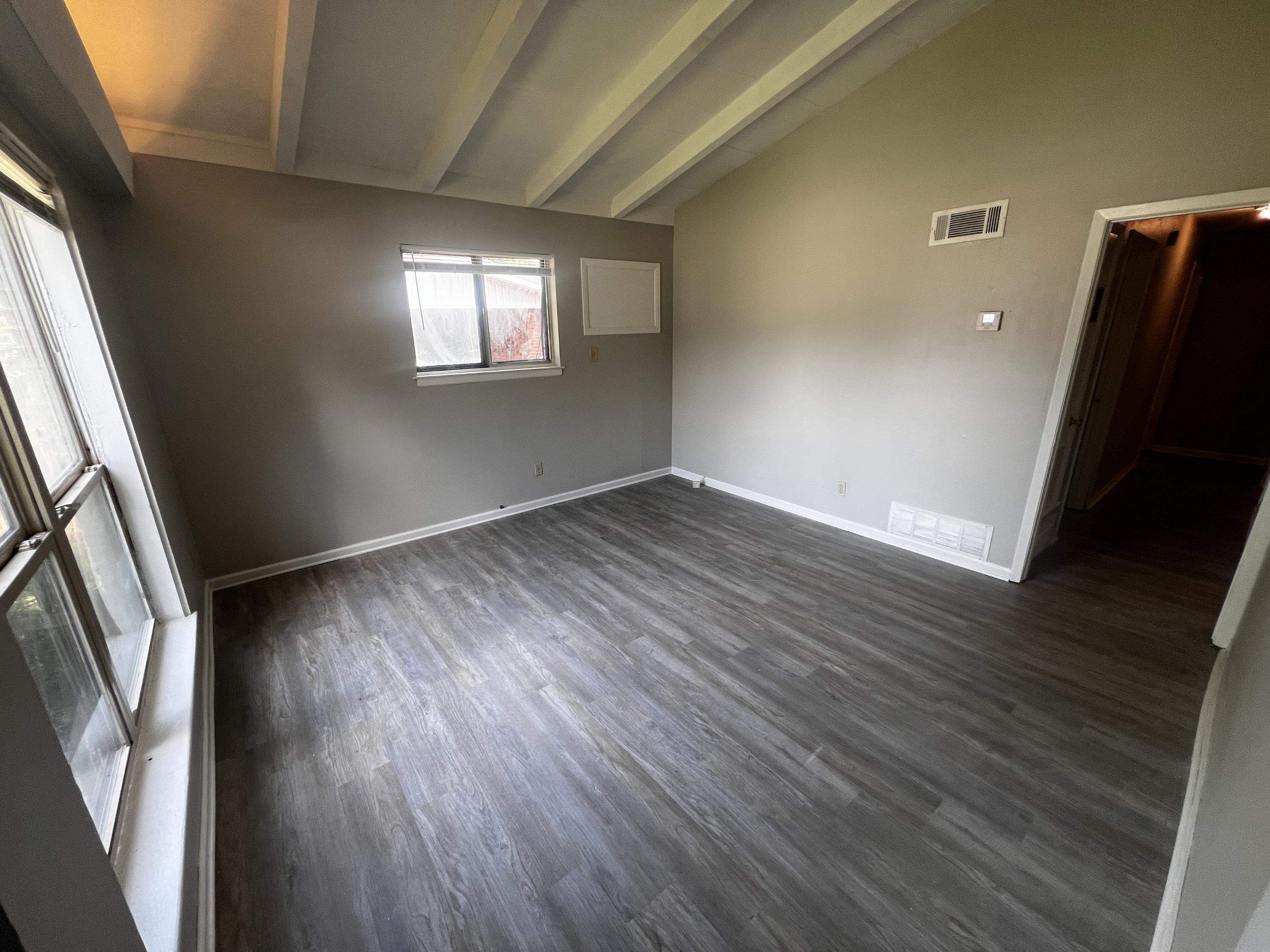 4523 Lawrence Road Memphis, TN 38122 - Photo 2 of 11 an empty room with wooden floor and windows