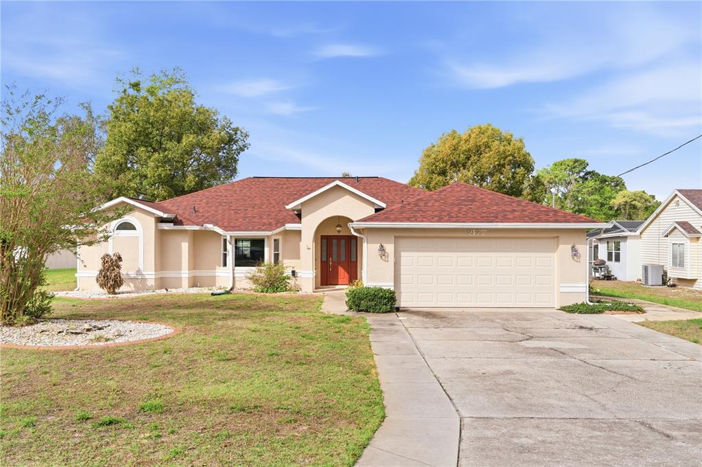 2177 Champlain Avenue Spring Hill, FL 34609 - Photo 1 of 1 a front view of a house with a yard