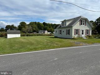 6343 Bozman Neavitt Road Neavitt, MD 21652 - Photo 20 of 23 a front view of a house with a garden and trees