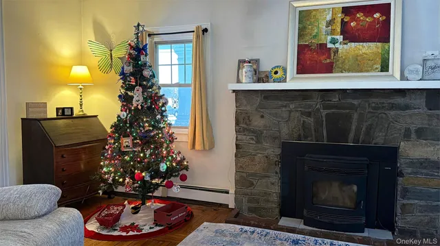 a room with a fireplace and a potted plant
