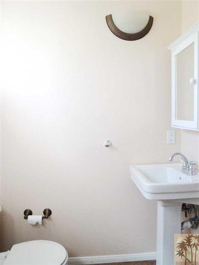 6620 Outpost Road Joshua Tree, CA 92252 - Photo 13 of 24 a bathroom with a sink a toilet and a mirror
