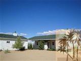 6620 Outpost Road Joshua Tree, CA 92252 - Photo 20 of 24 a front view of a house with a yard