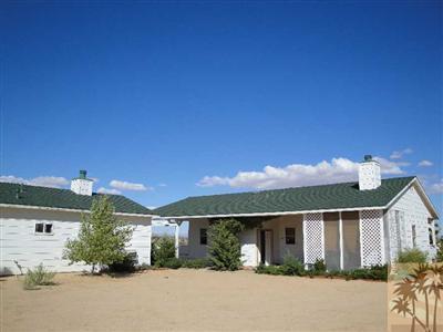 6620 Outpost Road Joshua Tree, CA 92252 - Photo 2 of 24 front view of a house with a street