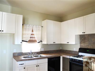 6620 Outpost Road Joshua Tree, CA 92252 - Photo 3 of 24 a kitchen with granite countertop a sink a stove and cabinets