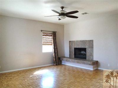 6620 Outpost Road Joshua Tree, CA 92252 - Photo 5 of 24 a view of an empty room with a fireplace and a window