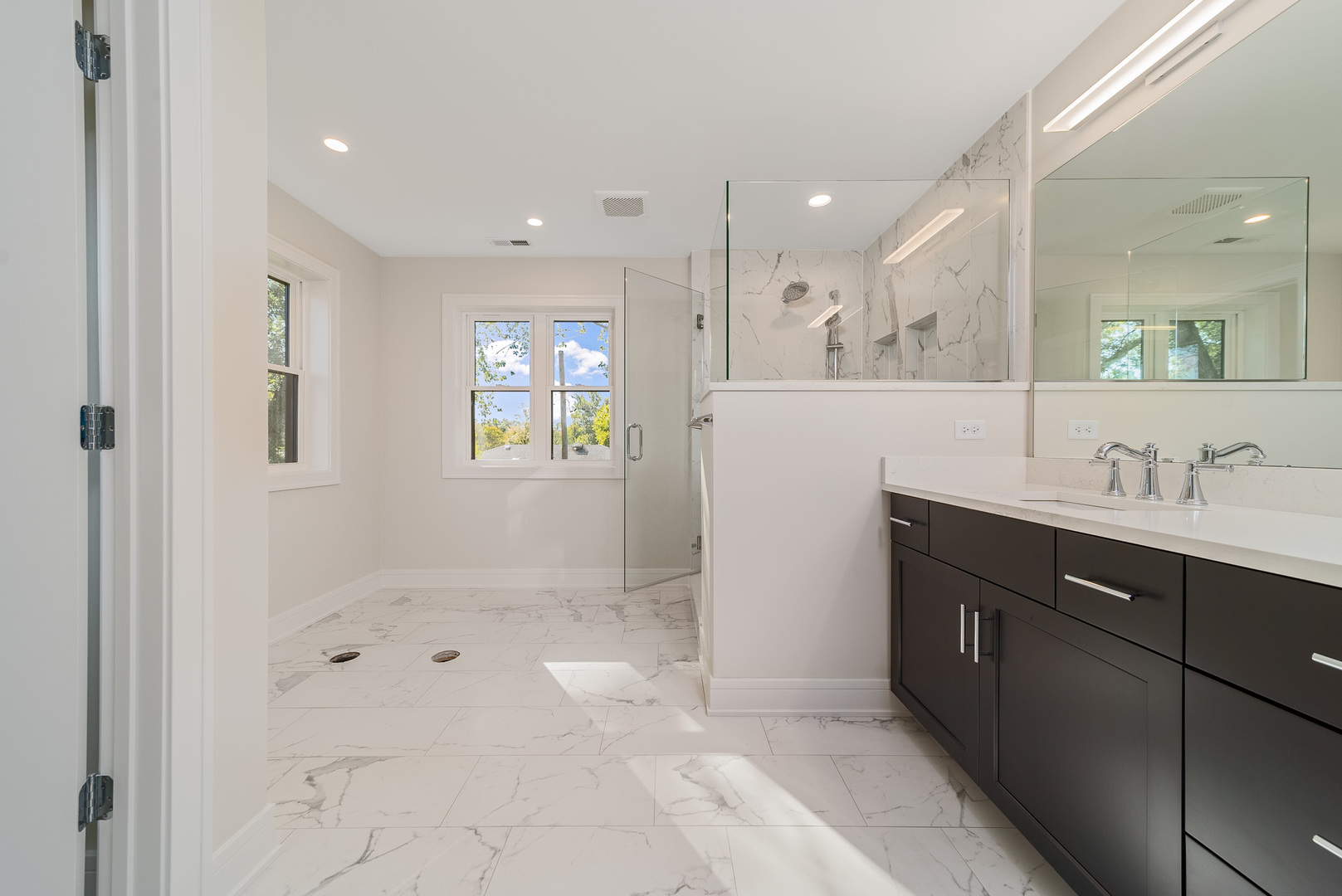 315 Walnut Street Elmhurst, IL 60126 - Photo 24 of 39 a spacious bathroom with a shower sink and mirror