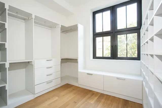 a en suite bathroom with a bathtub double sink and mirror