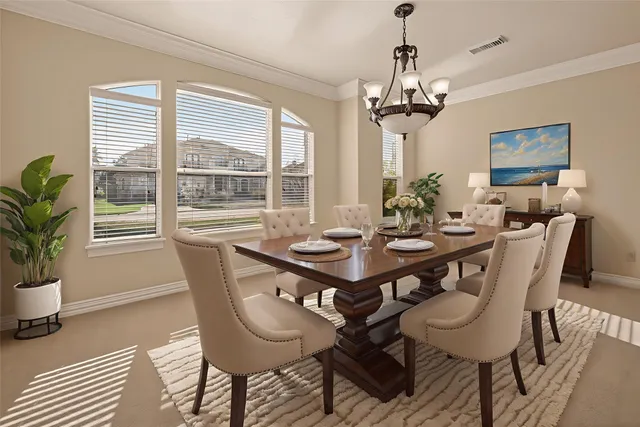 a bedroom with a large bed and a flat tv screen on dresser