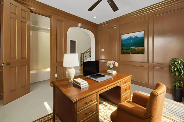 a view of an empty room with a ceiling fan and window