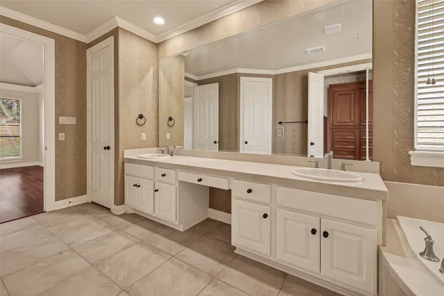 a bathroom with a granite countertop sink a mirror and a shower