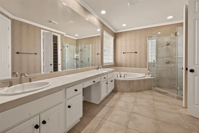 a spacious bedroom with a bed and a flat screen tv