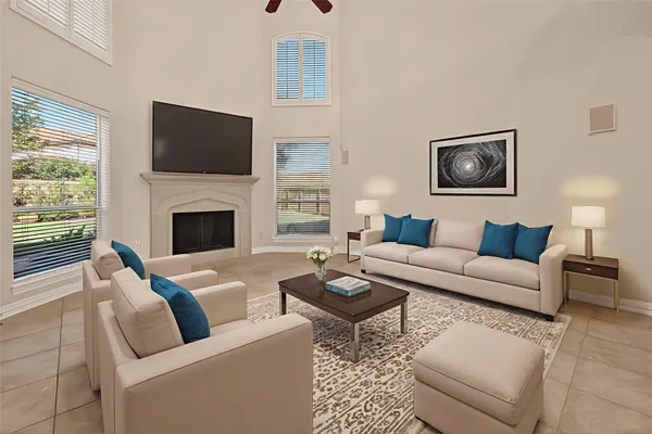 an empty room with fireplace and windows
