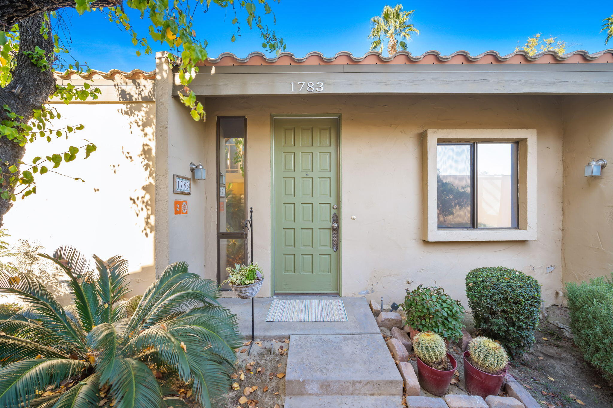1783 Ramon Road, Unit 2 Palm Springs, CA 92264 - Photo 1 of 18 a front view of a house with a yard