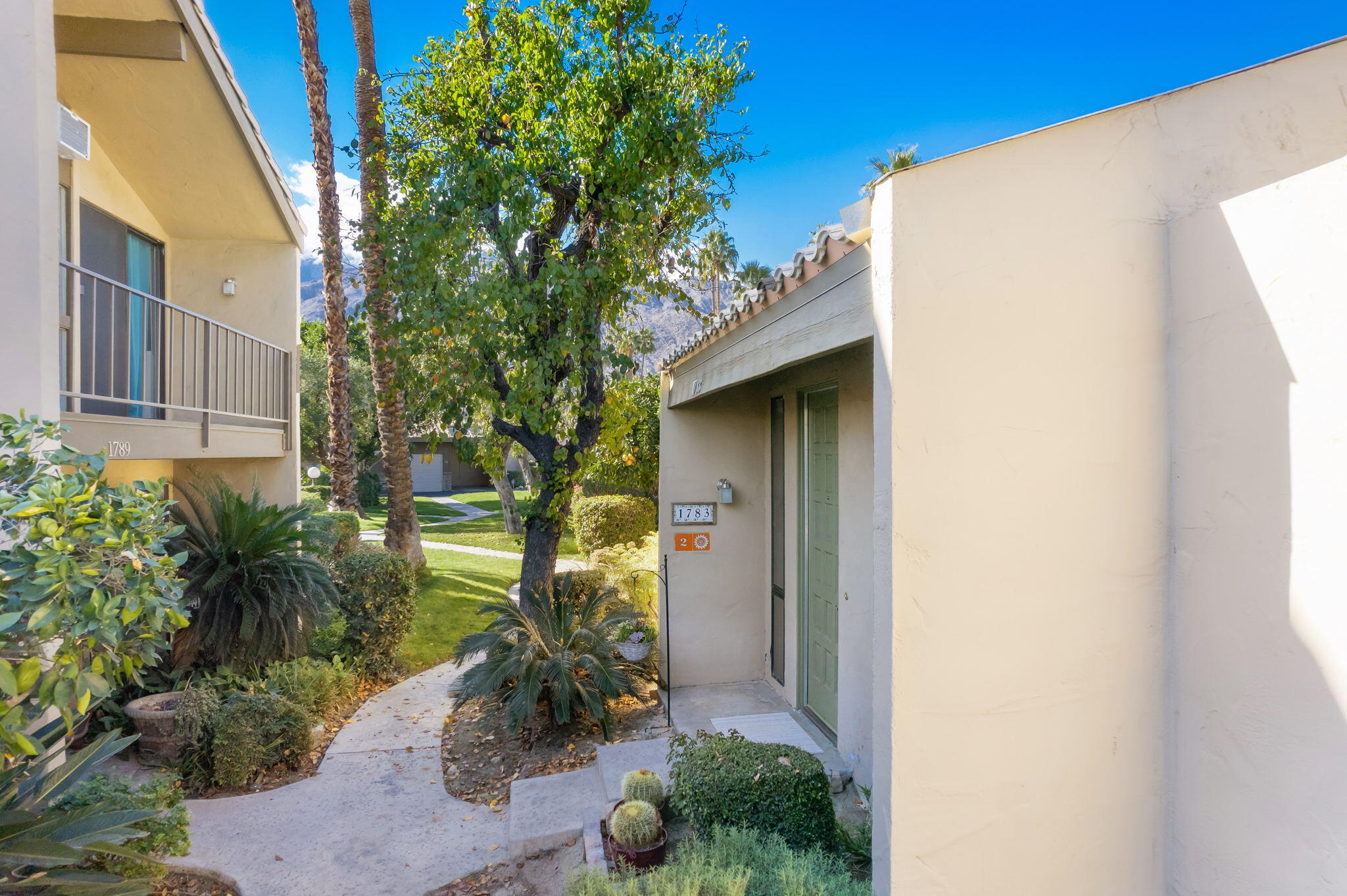 1783 Ramon Road, Unit 2 Palm Springs, CA 92264 - Photo 2 of 18 a yellow house with outdoor space