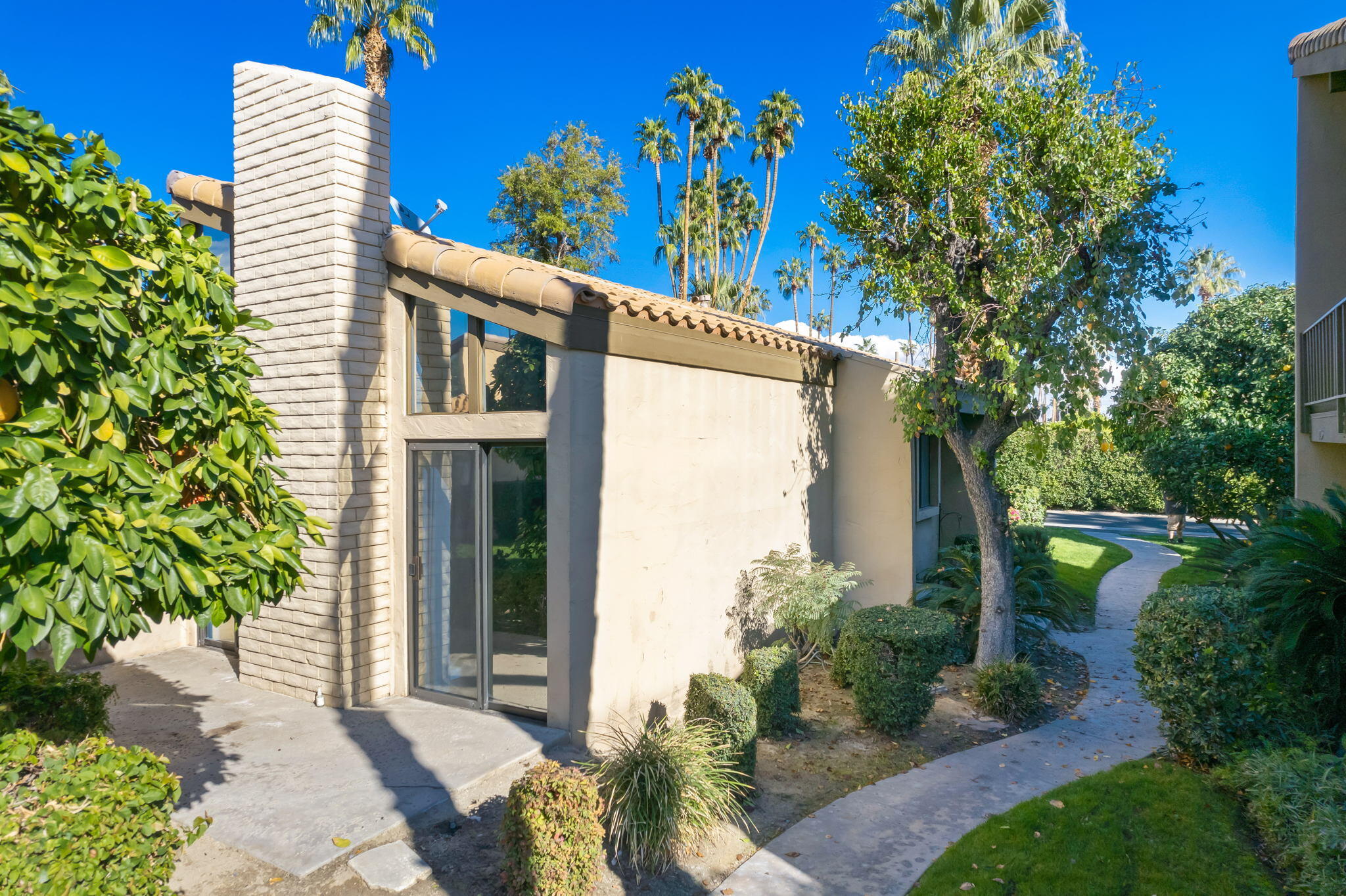 1783 Ramon Road, Unit 2 Palm Springs, CA 92264 - Photo 3 of 18 a front view of a house with a garden