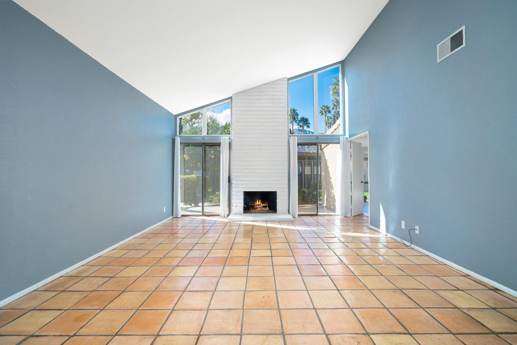 1783 Ramon Road, Unit 2 Palm Springs, CA 92264 - Photo 4 of 18 a view of an empty room with a fireplace and a window