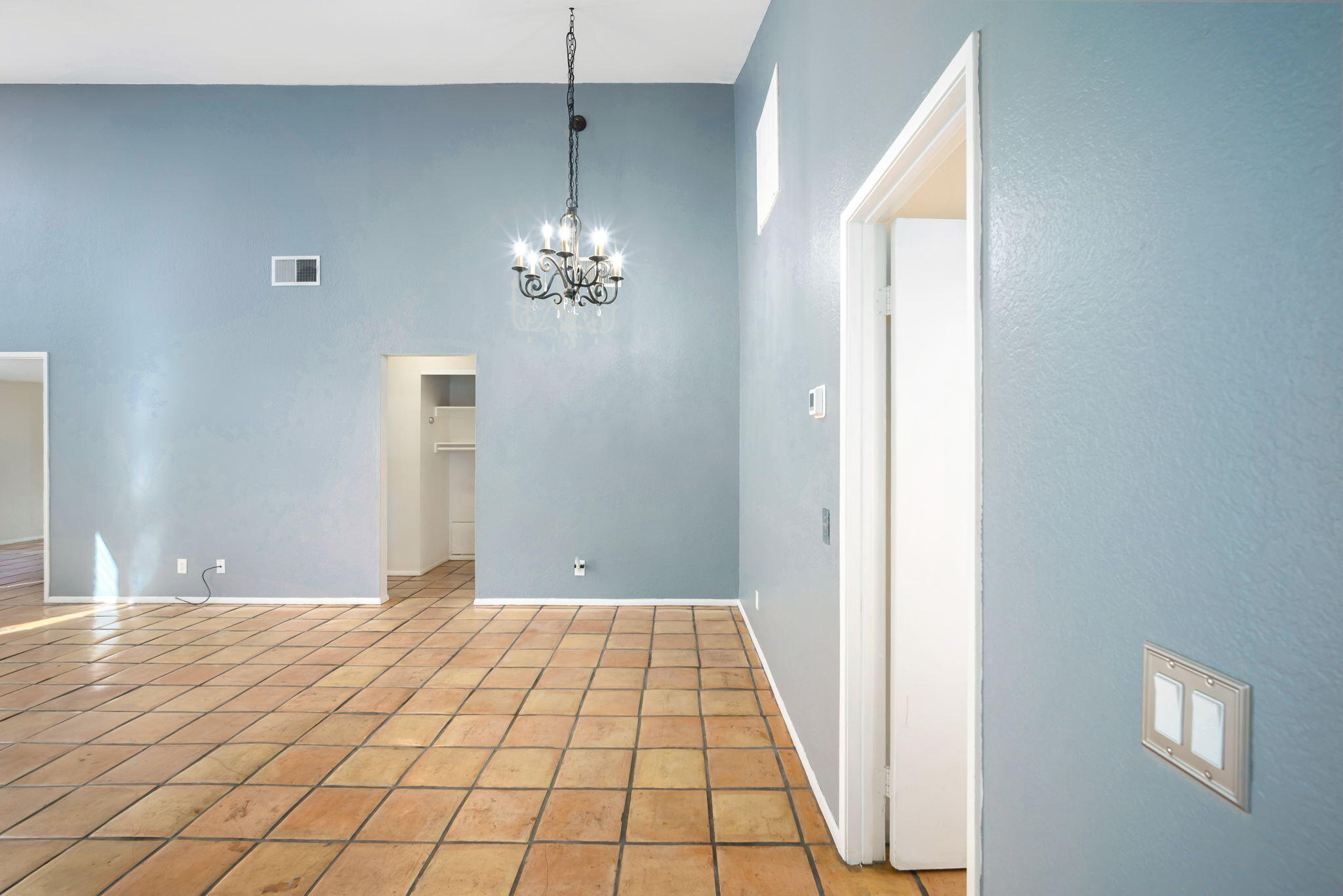1783 Ramon Road, Unit 2 Palm Springs, CA 92264 - Photo 6 of 18 a view of an empty room with window and chandelier fan