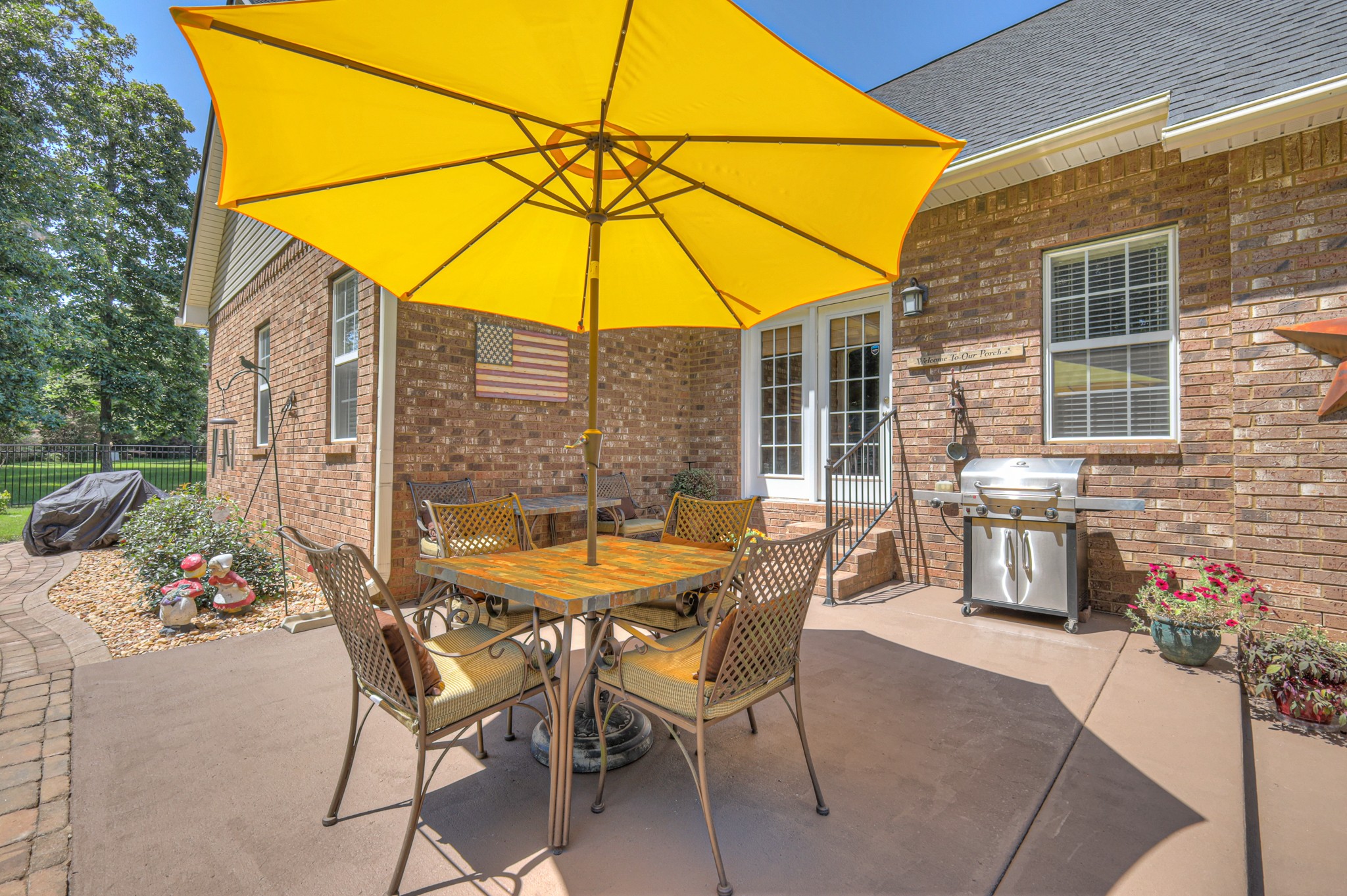 431 Conquest Road Murfreesboro, TN 37128 - Photo 45 of 55 a patio with a table and chairs under an umbrella