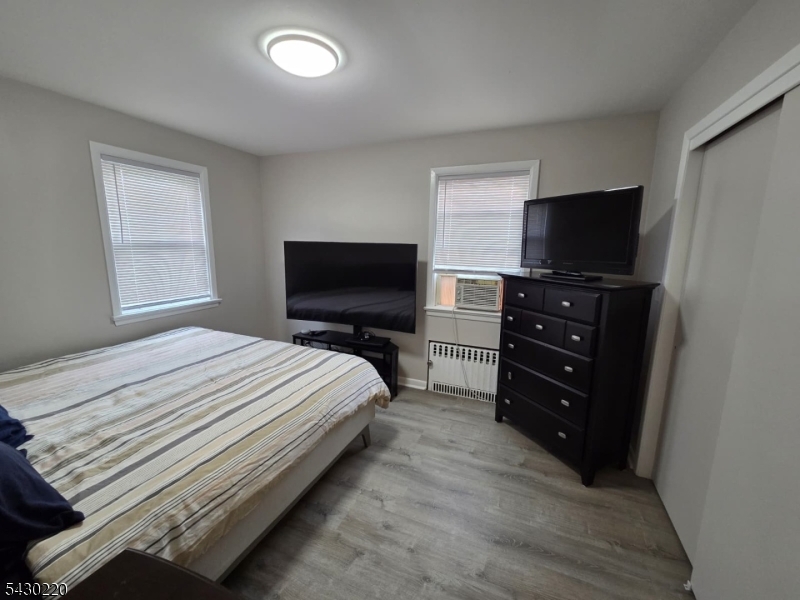 166 Carmita Avenue Rutherford, NJ 07070 - Photo 10 of 27 a bedroom with a bed and a television