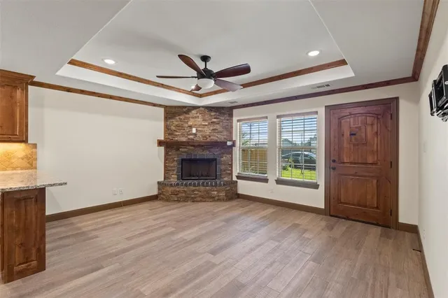 a view of an empty room with a fireplace and a window