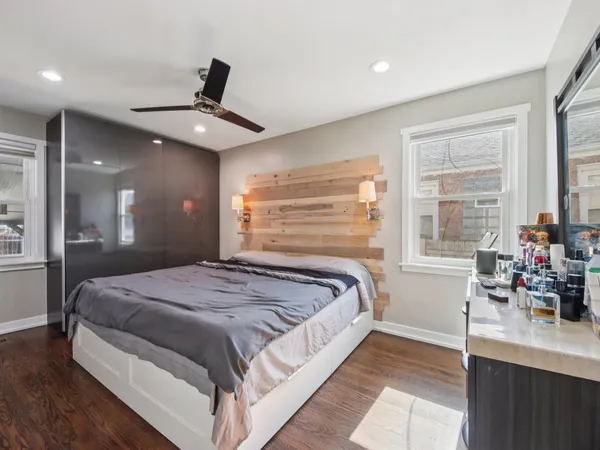 a bed sitting in a spacious bedroom next to a window