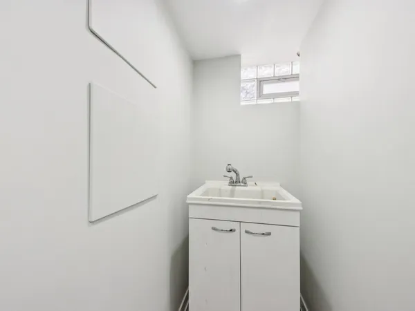 a bathroom with a toilet sink vanity granite and shower