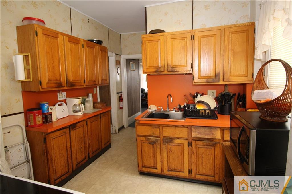 65 Station Road Cranbury, NJ 08512 - Photo 4 of 11 a kitchen with stainless steel appliances a refrigerator and a stove