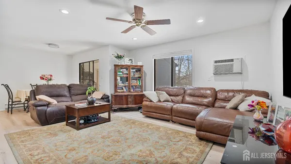 a living room with furniture ceiling fan and a rug