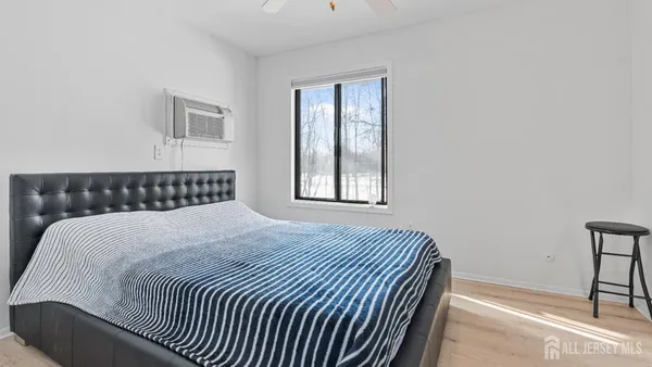 a bedroom with a bed and a window
