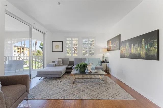 a living room with furniture potted plant and windows