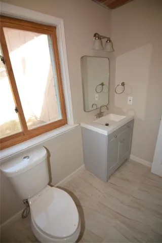 a bathroom with a toilet sink and mirror