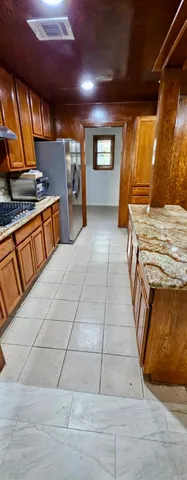 a view of a room with wooden floors