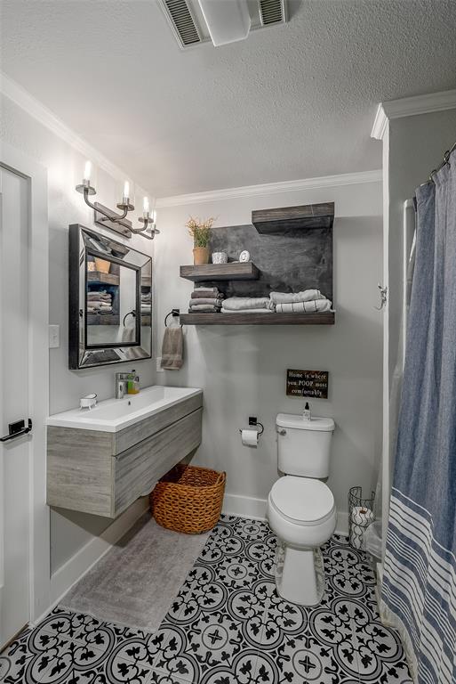 128 Knott Drive Many, LA 71449 - Photo 22 of 39 a bathroom with a granite countertop toilet a sink and a mirror