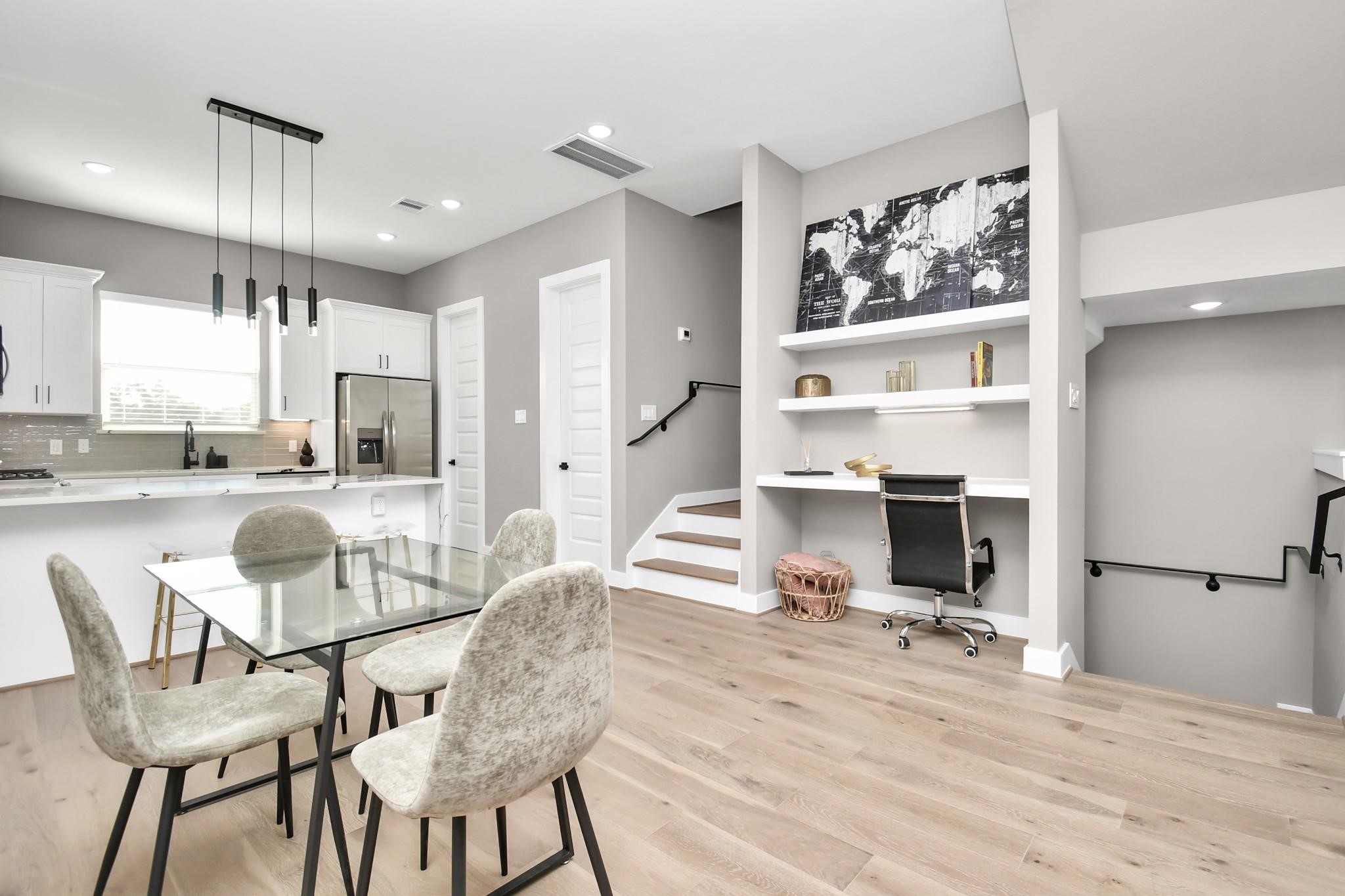 a view of a dining room with furniture a kitchen and chandelier