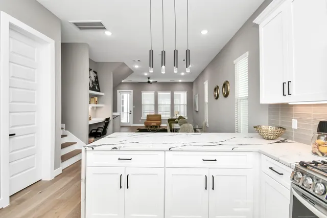 a kitchen with a refrigerator and cabinets
