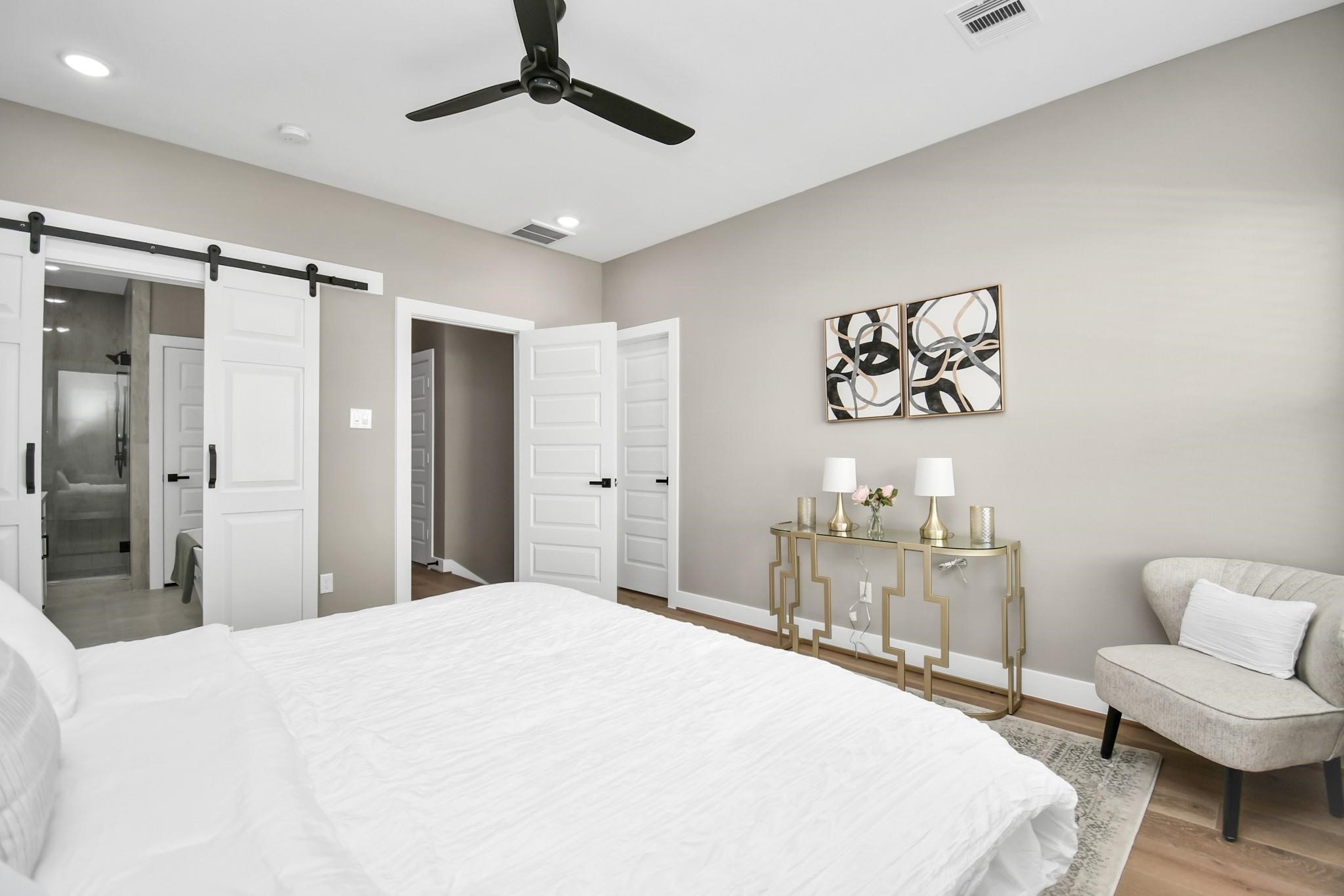 316 Thornton Road, Unit E Houston, TX 77018 - Photo 23 of 27 a bedroom with a bed and a chandelier