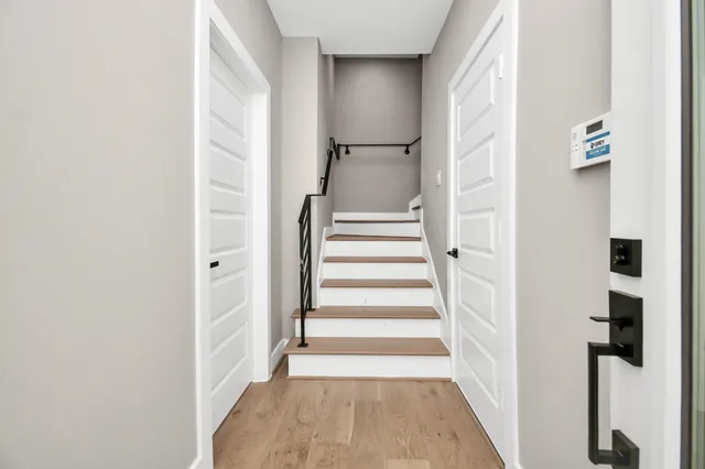 a view of a hallway with wooden floor and entryway