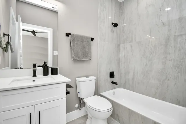 a bathroom with a sink a toilet and shower curtain