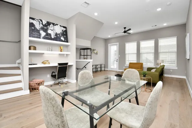 a living room with furniture a rug and white walls