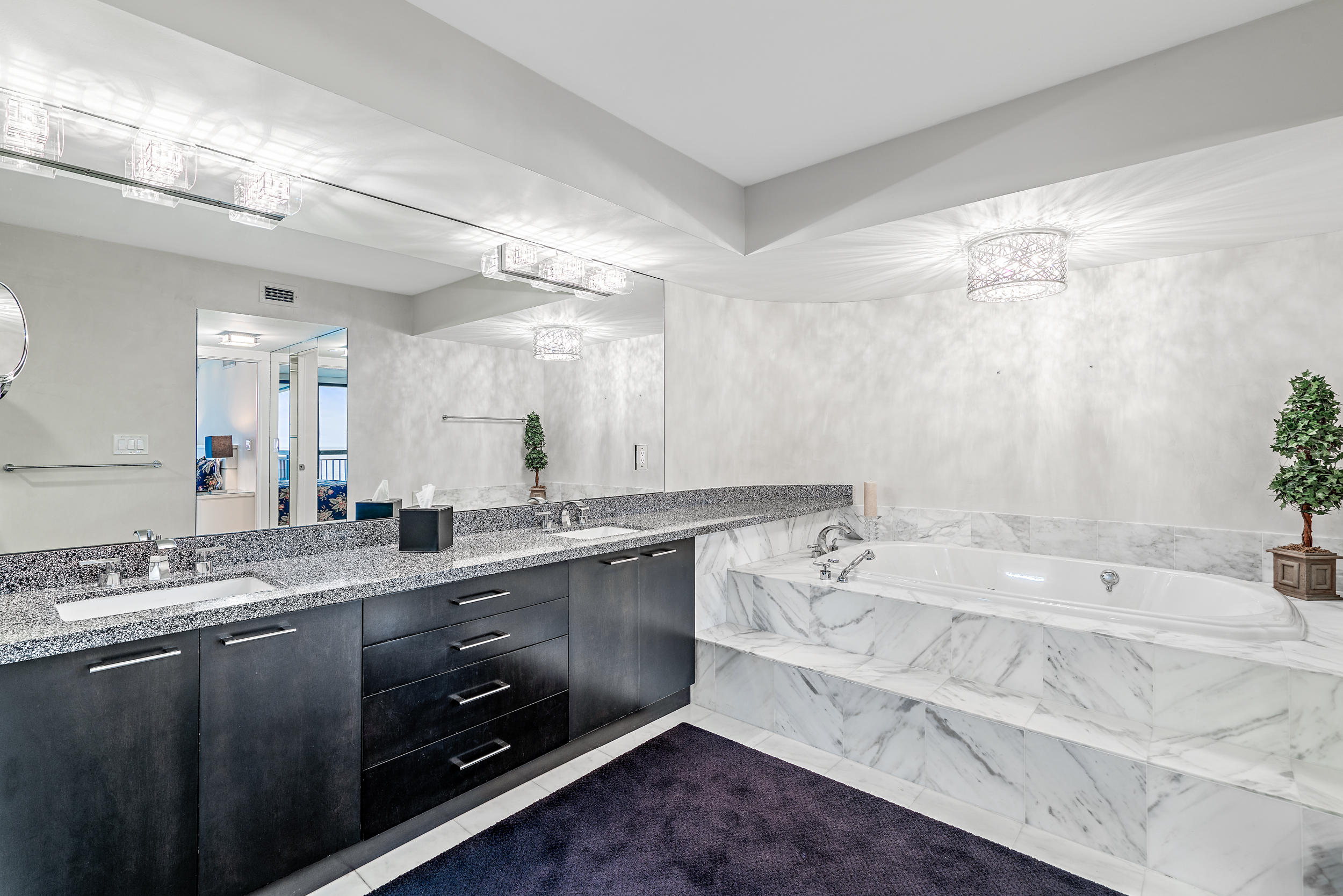 5380 North Ocean Drive, Unit 10J Singer Island, FL 33404 - Photo 13 of 37 a spacious bathroom with a granite countertop sink mirror and bathtub