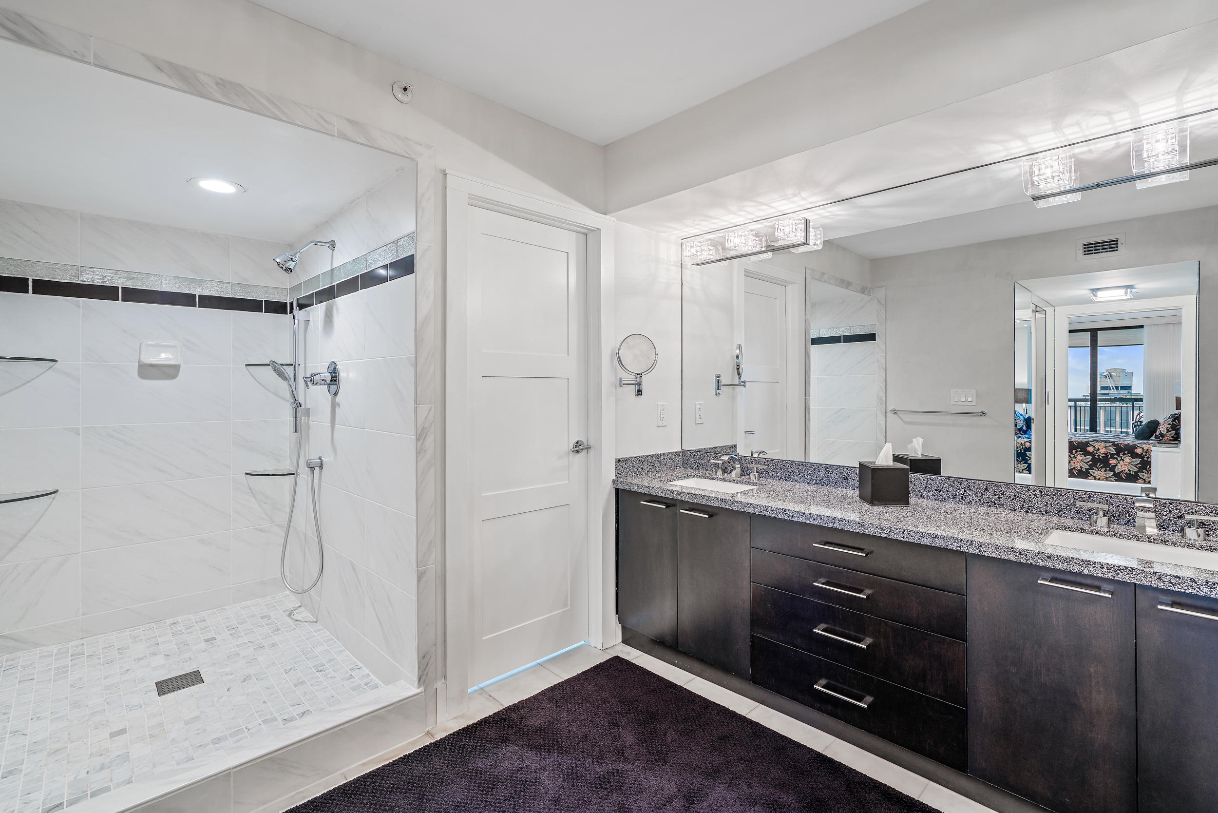 5380 North Ocean Drive, Unit 10J Singer Island, FL 33404 - Photo 14 of 37 a bathroom with a granite countertop sink mirror and shower