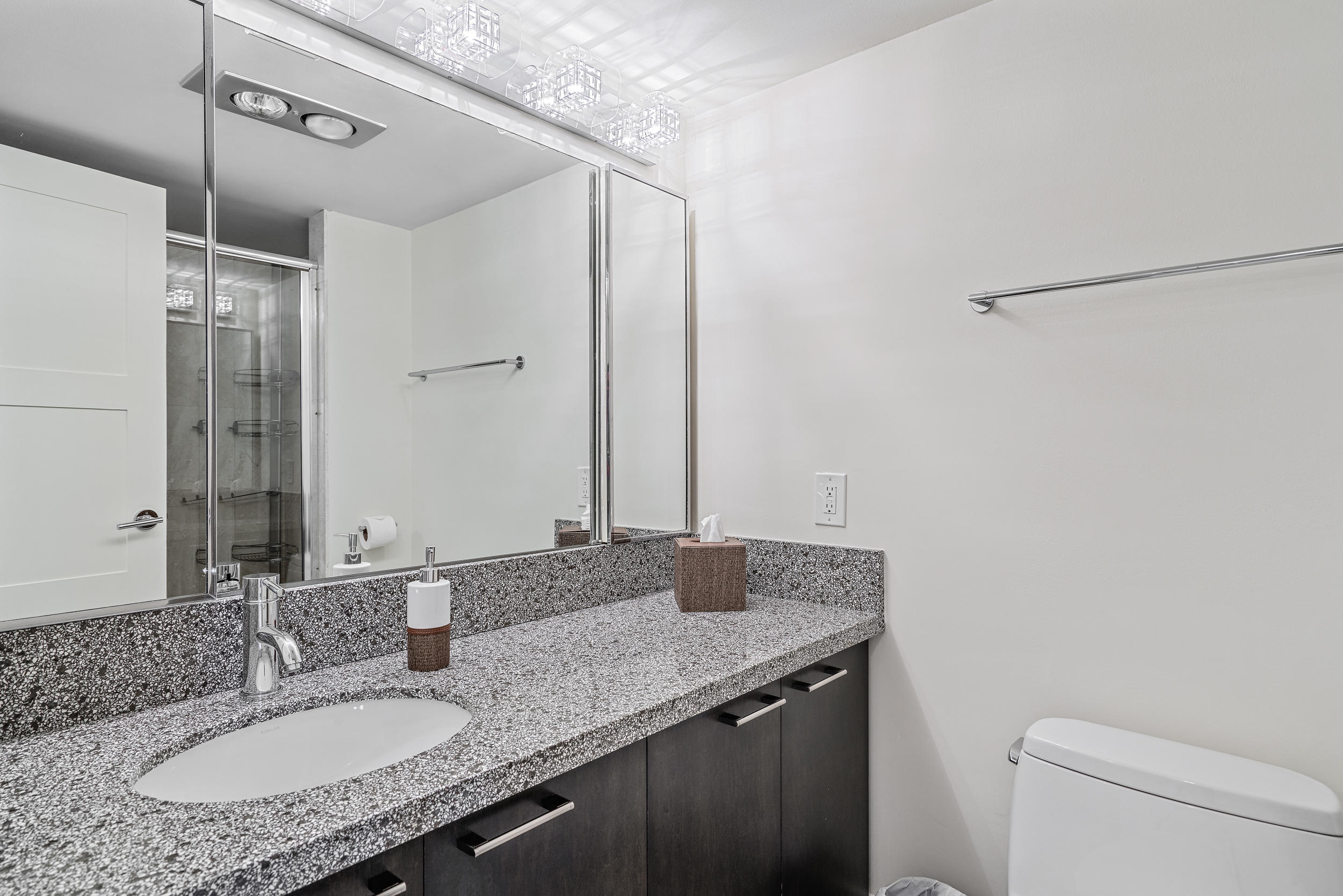5380 North Ocean Drive, Unit 10J Singer Island, FL 33404 - Photo 16 of 37 a bathroom with a granite countertop sink and a mirror