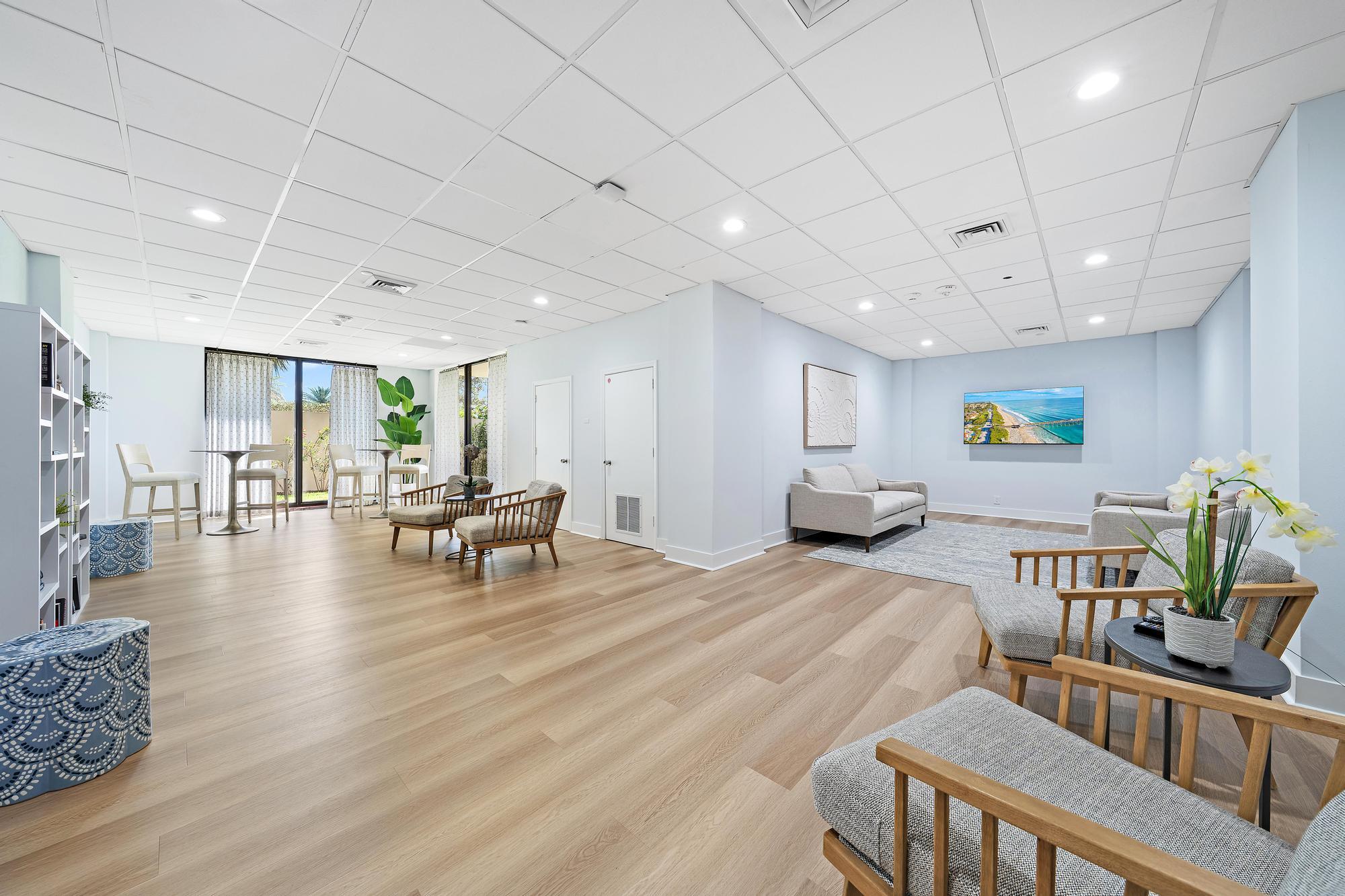 5380 North Ocean Drive, Unit 10J Singer Island, FL 33404 - Photo 29 of 37 a living room with furniture and a table with wooden floor
