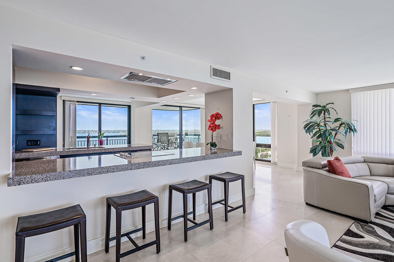 5380 North Ocean Drive, Unit 10J Singer Island, FL 33404 - Photo 5 of 37 a large living room with stainless steel appliances kitchen island granite countertop furniture and a large window