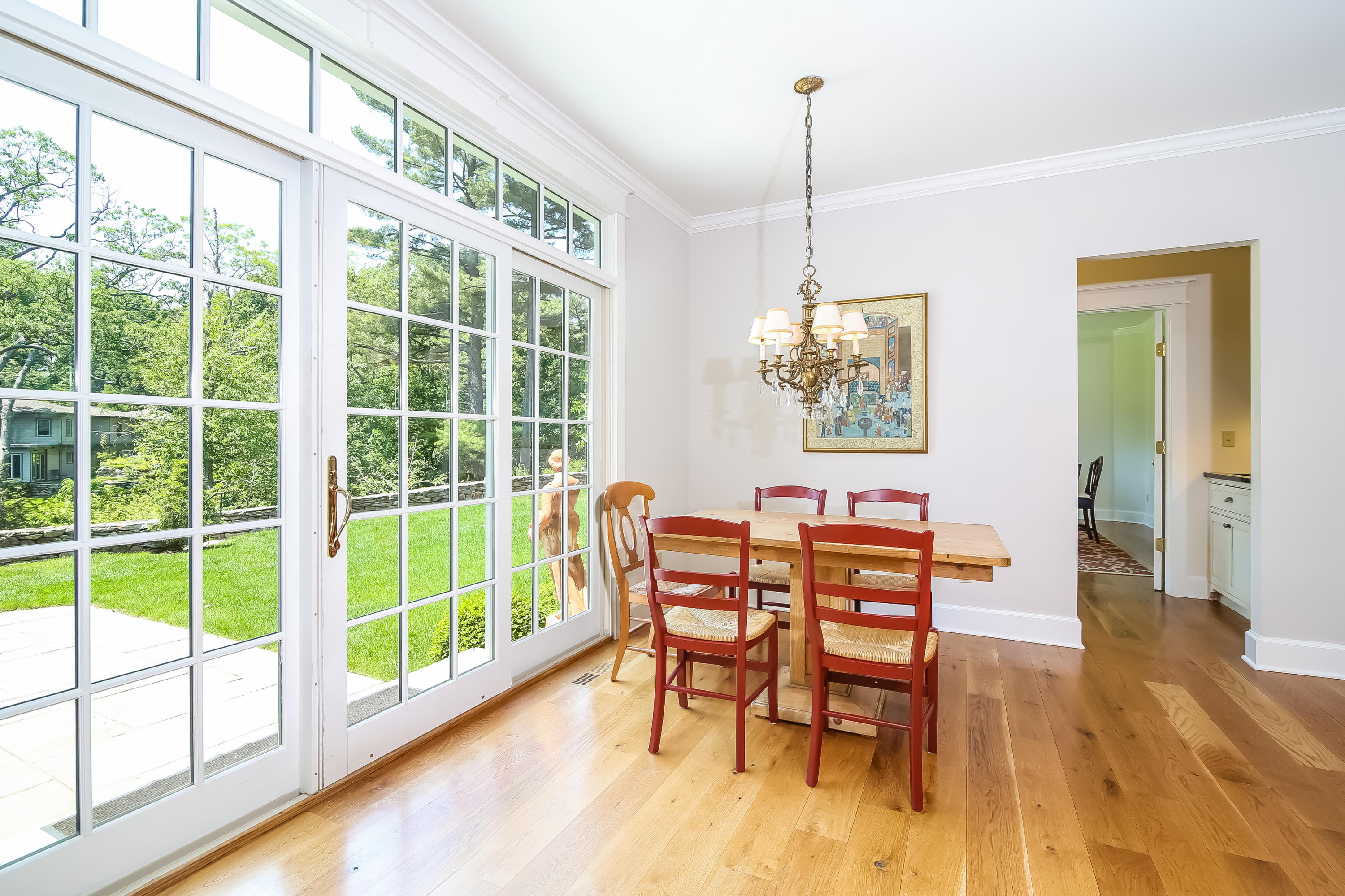 65 Goodwives River Road Darien, CT 06820 - Photo 11 of 36 a dining room with furniture a chandelier and wooden floor