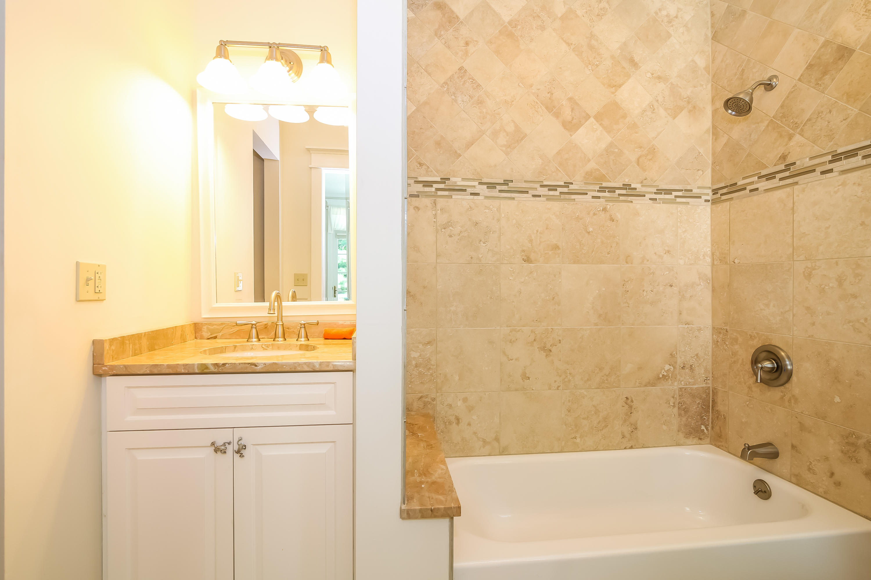 65 Goodwives River Road Darien, CT 06820 - Photo 24 of 36 a bathroom with a granite countertop sink and a bathtub