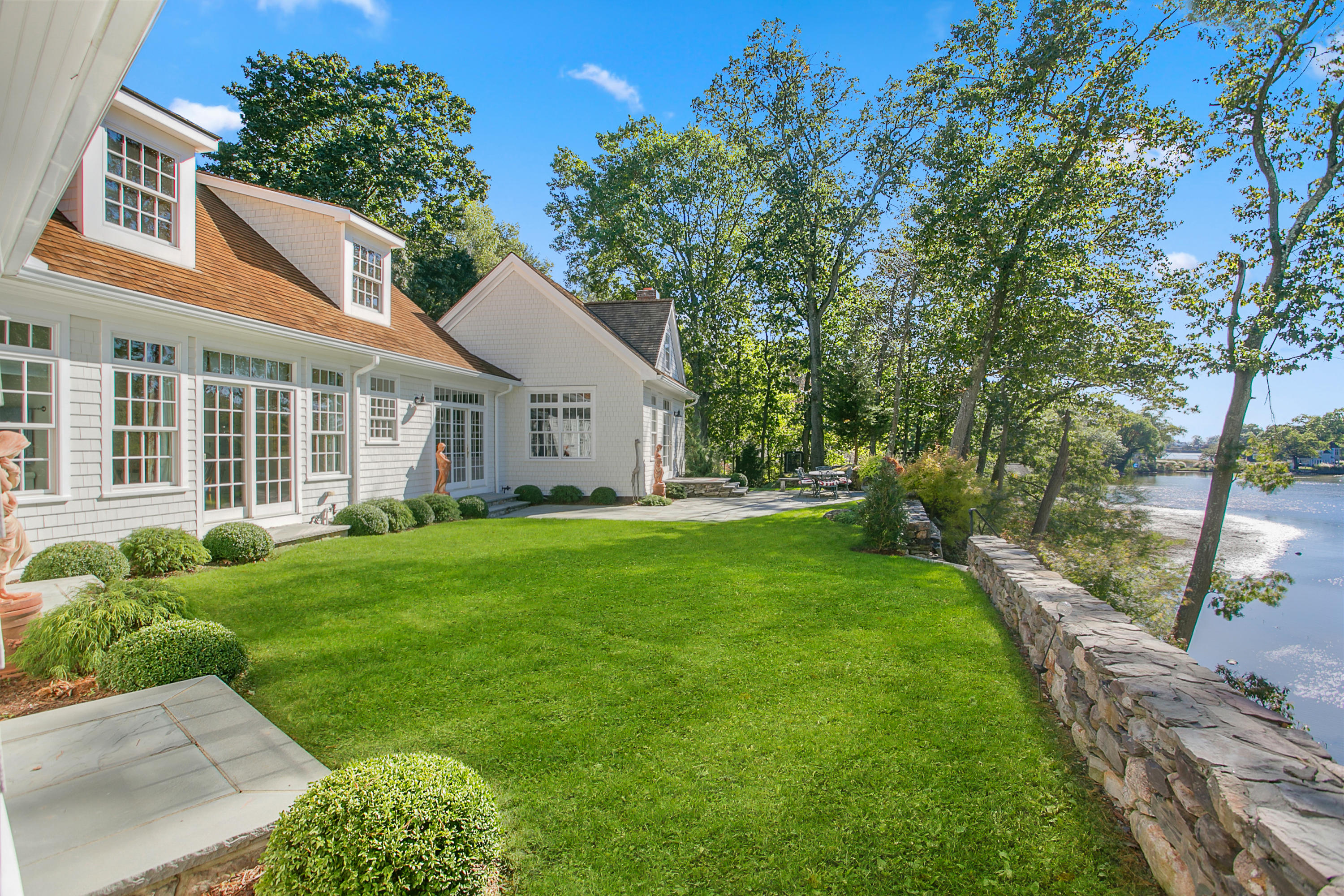 65 Goodwives River Road Darien, CT 06820 - Photo 30 of 36 a view of a house with yard and green space