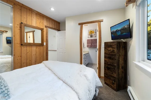 a bedroom with a bed and a flat screen tv