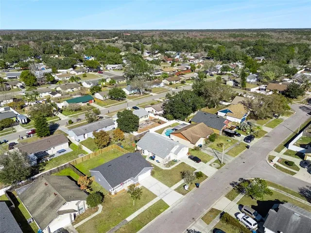 an aerial view of residential houses with outdoor space